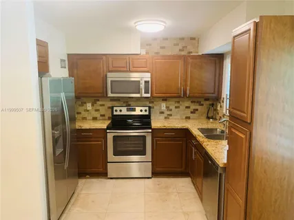 a kitchen with stainless steel appliances a refrigerator stove and sink