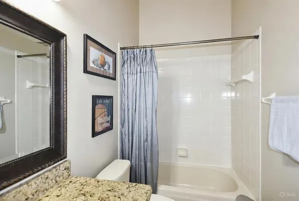a bathroom with a shower and a tub
