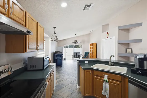 a kitchen with counter top space sink stove and oven