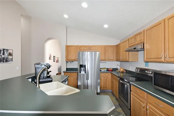 a kitchen with a sink a stove and refrigerator