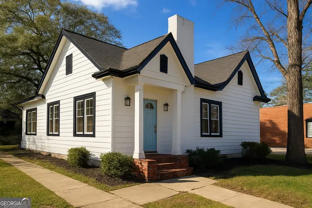 a front view of a house with garden