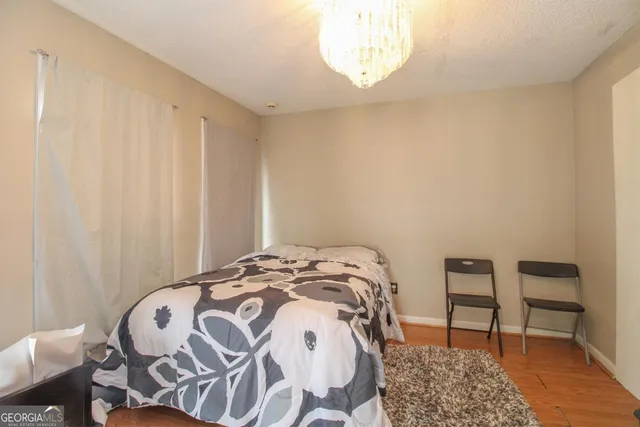 a bedroom with a bed and a chair