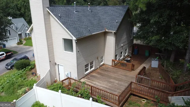 a view of house with backyard and glass windows