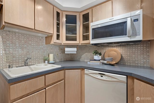 a kitchen with stainless steel appliances granite countertop a sink stove and microwave