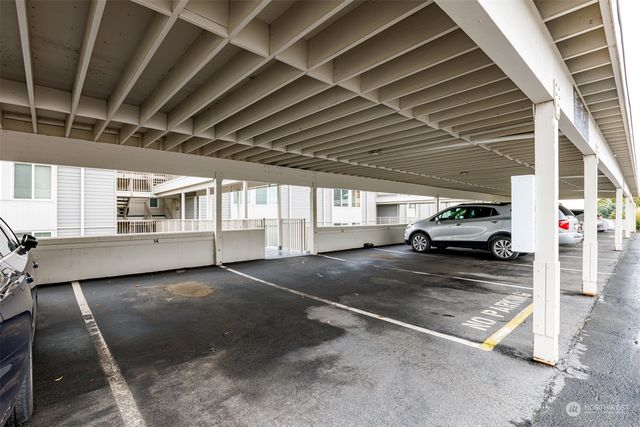 a view of a house with pool and wooden fence