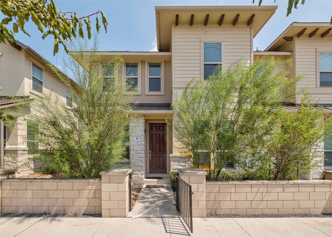 a front view of a house with a garden
