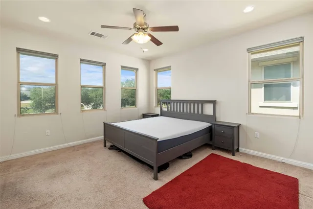 a bedroom with a bed next to a window