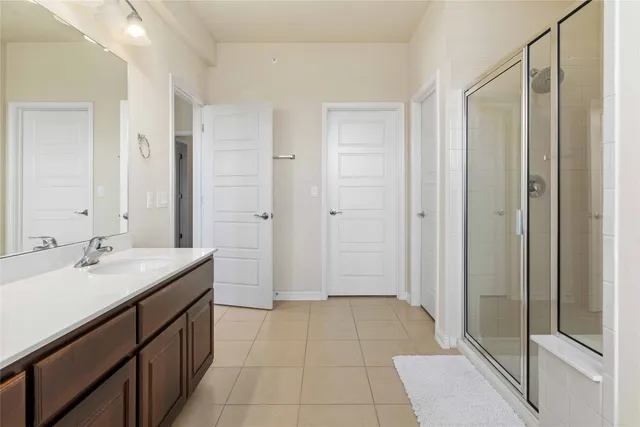 a bathroom with a sink a mirror and a shower