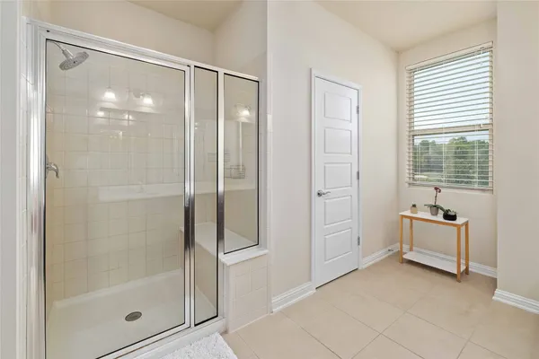 a bathroom with a tub shower and sink