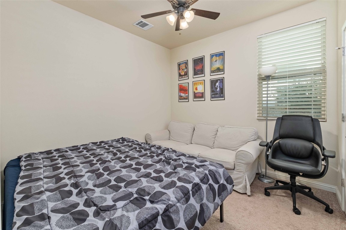 6814 East Riverside Drive, Unit 31 Austin, TX 78741 - Photo 19 of 25 a bedroom with a bed and a chair