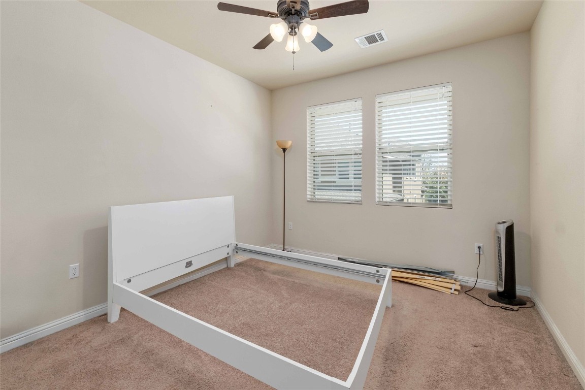 6814 East Riverside Drive, Unit 31 Austin, TX 78741 - Photo 20 of 25 an empty room with windows and ceiling fan