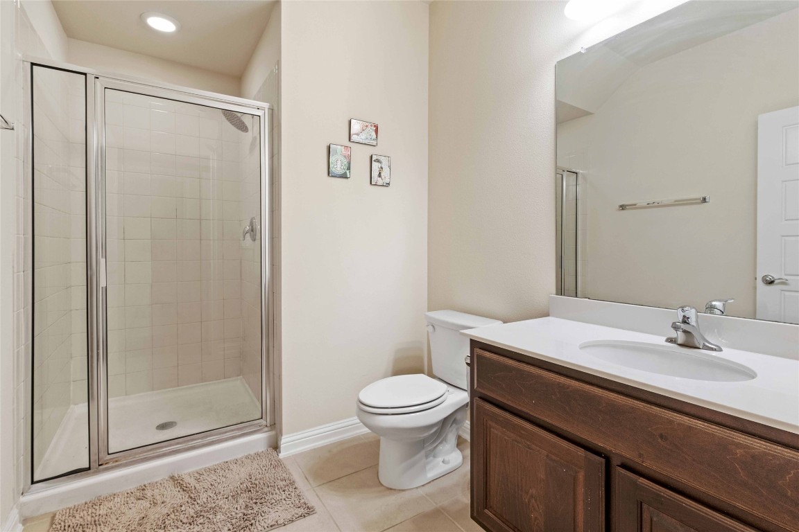 6814 East Riverside Drive, Unit 31 Austin, TX 78741 - Photo 21 of 25 a bathroom with a sink a toilet and shower