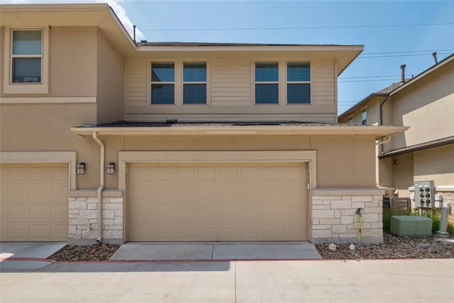 a front view of a house with garage