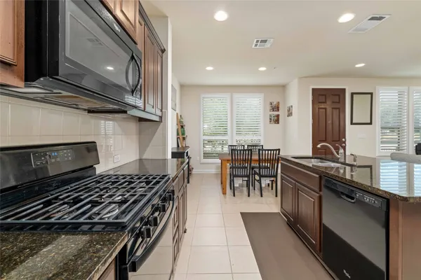 a kitchen with lots of counter top space and stainless steel appliances