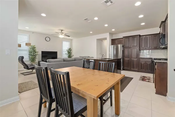 a large kitchen with a table and chairs