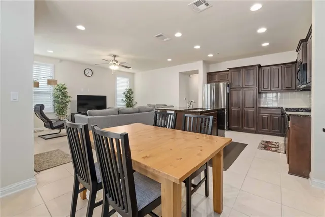 a large kitchen with a table and chairs