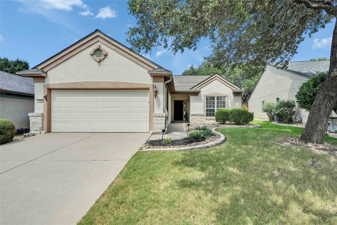 114 Yellowstone Road Georgetown, TX 78633 - Photo 1 of 1 Ranch-style home featuring stucco siding, driveway, an attached garage, a front lawn, and stone siding