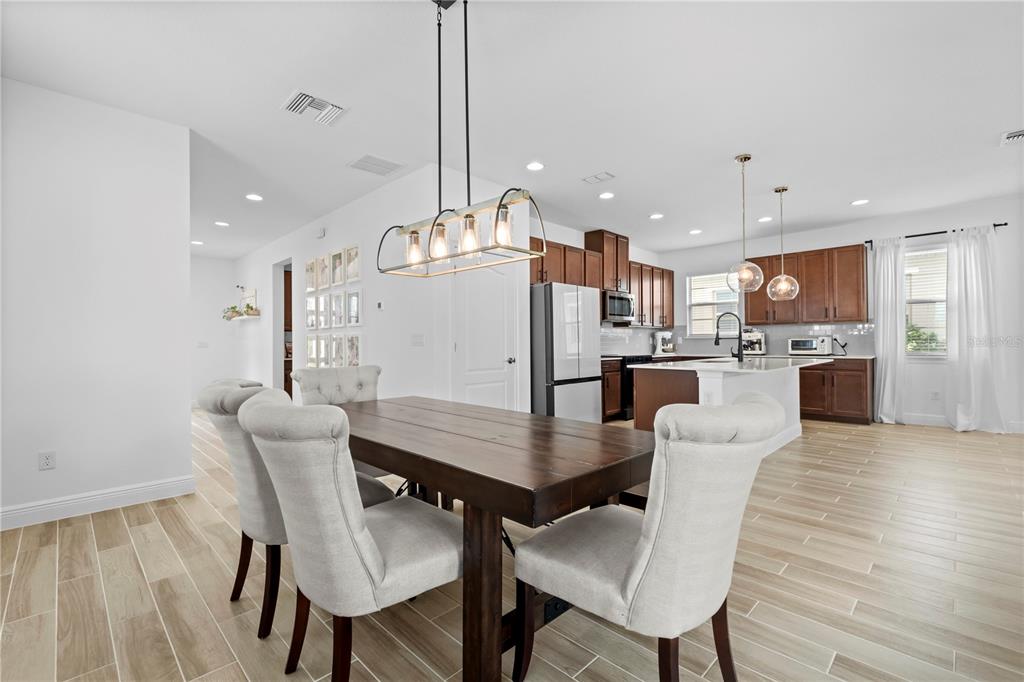6699 Alder Road St. Cloud, FL 34773 - Photo 15 of 51 a view of a dining room with furniture wooden floor and a chandelier