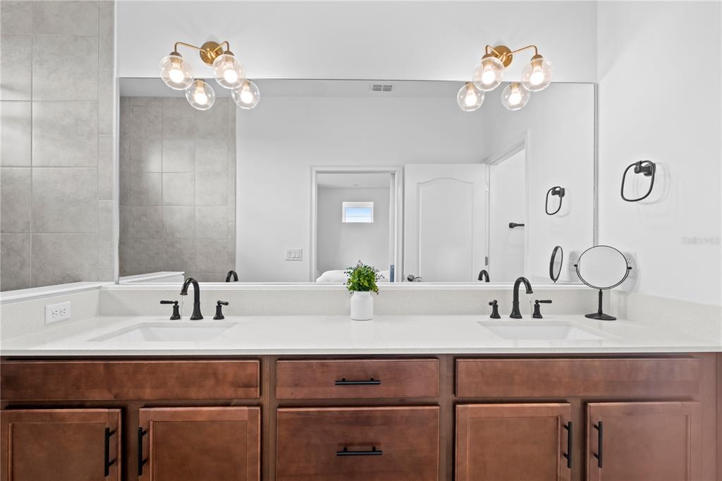 6699 Alder Road St. Cloud, FL 34773 - Photo 21 of 51 a bathroom with a sink and a mirror