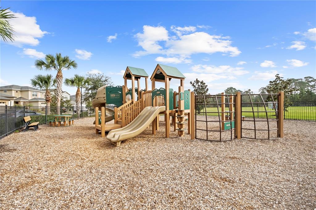 6699 Alder Road St. Cloud, FL 34773 - Photo 35 of 51 a view of a park with swings and slides