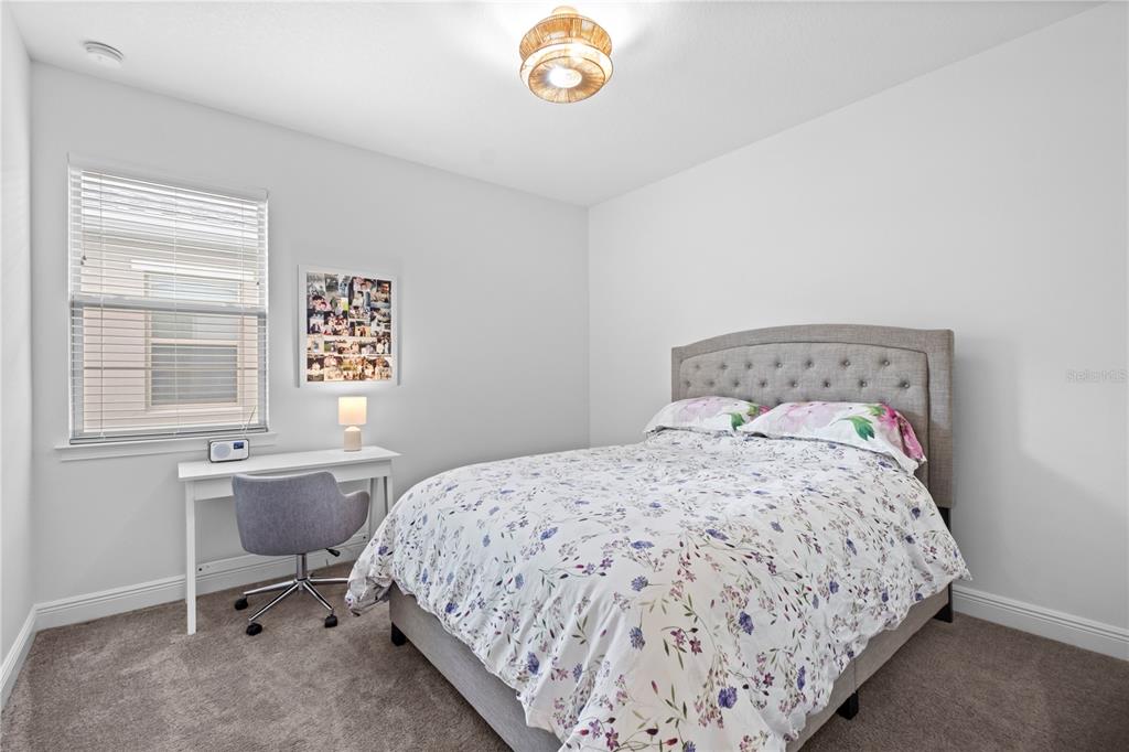 6699 Alder Road St. Cloud, FL 34773 - Photo 8 of 51 a bedroom with a bed and a window