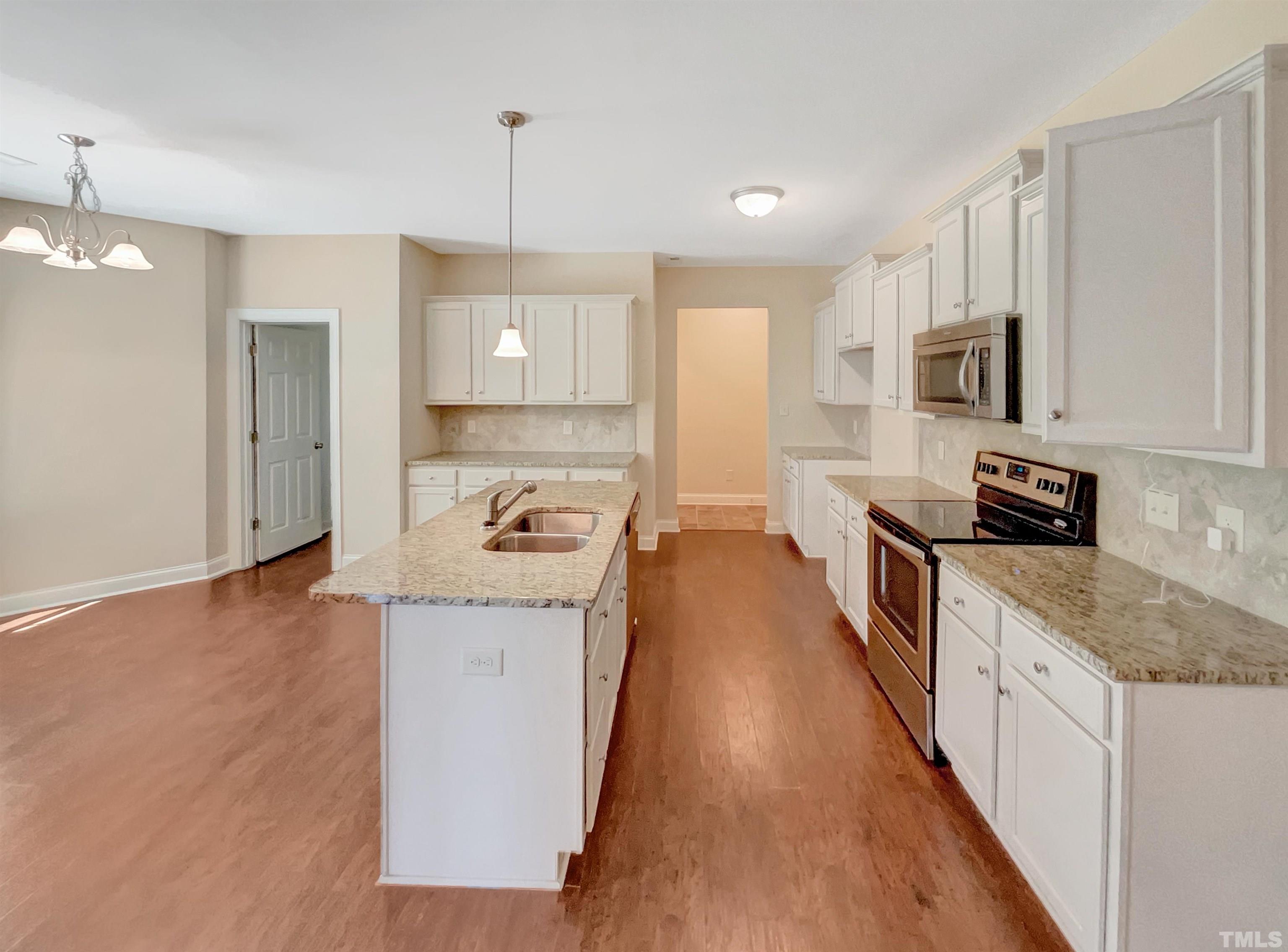 144 Phobos Place Garner, NC 27529 - Photo 2 of 19 a kitchen with stainless steel appliances granite countertop a sink stove and refrigerator