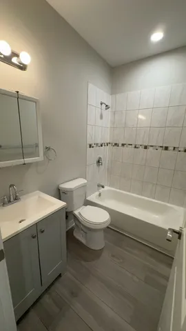 a bathroom with a toilet a sink and bathtub