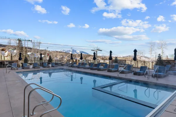 a view of a swimming pool with a deck and living room