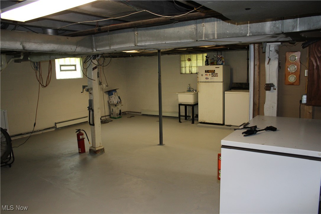 10816 Green Road Wakeman, OH 44889 - Photo 17 of 25 Basement featuring freestanding refrigerator, white fridge, and washer / clothes dryer