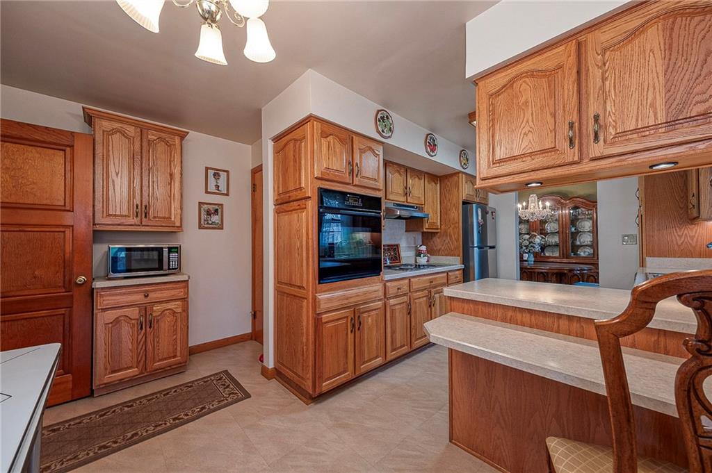 1913 Brigadoon Lane New Castle, PA 16101 - Photo 11 of 30 a kitchen with stainless steel appliances granite countertop a refrigerator and cabinets
