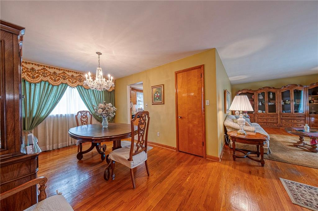 1913 Brigadoon Lane New Castle, PA 16101 - Photo 13 of 30 a view of a dining room with furniture a chandelier and wooden floor