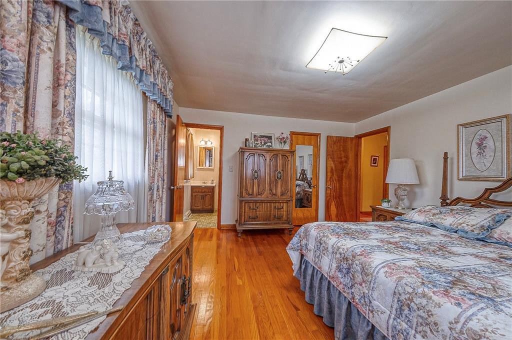 1913 Brigadoon Lane New Castle, PA 16101 - Photo 16 of 30 a bedroom with a large bed and a chandelier