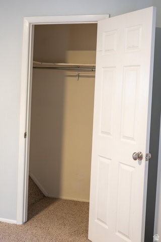 1269 North 400 East, Unit 3 Logan, UT 84341 - Photo 21 of 23 Recessed closet with a single hanging rod, upper shelf, and neutral carpeting