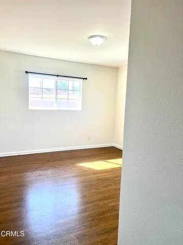 a view of a hallway with a wooden door