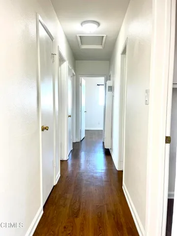 a kitchen with granite countertop white cabinets and wooden floor