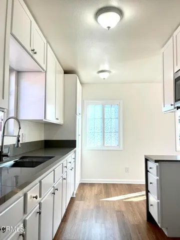 a view of a room with wooden floor
