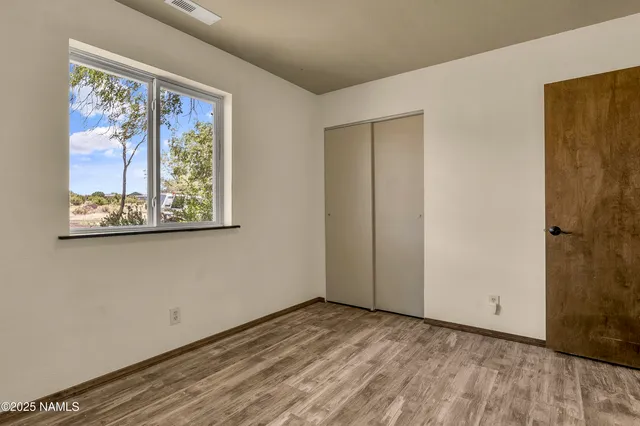 a view of an empty room with painting on the wall