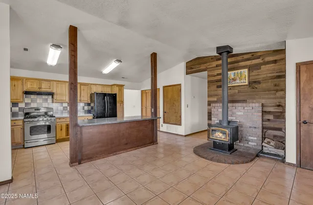a kitchen with stainless steel appliances granite countertop a stove and a refrigerator