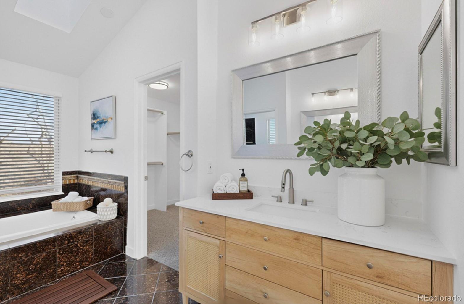 9195 Sugarstone Circle Highlands Ranch, CO 80130 - Photo 13 of 37 a bathroom with a sink a mirror and a potted plant