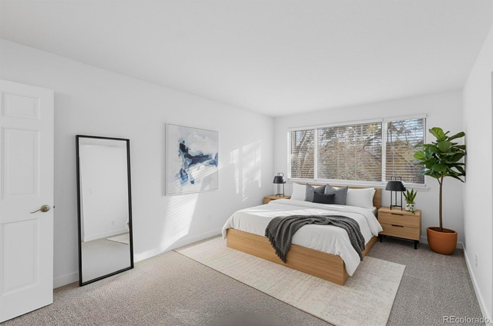 9195 Sugarstone Circle Highlands Ranch, CO 80130 - Photo 16 of 37 a bedroom with a large bed and a potted plant