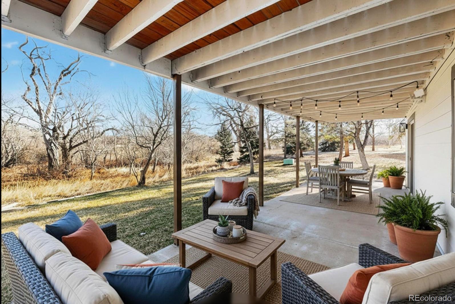9195 Sugarstone Circle Highlands Ranch, CO 80130 - Photo 19 of 37 a living room with furniture and a floor to ceiling window