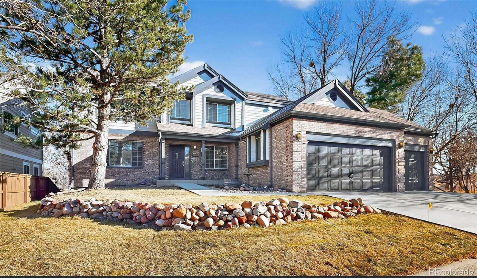 9195 Sugarstone Circle Highlands Ranch, CO 80130 - Photo 2 of 37 a front view of a house with a yard