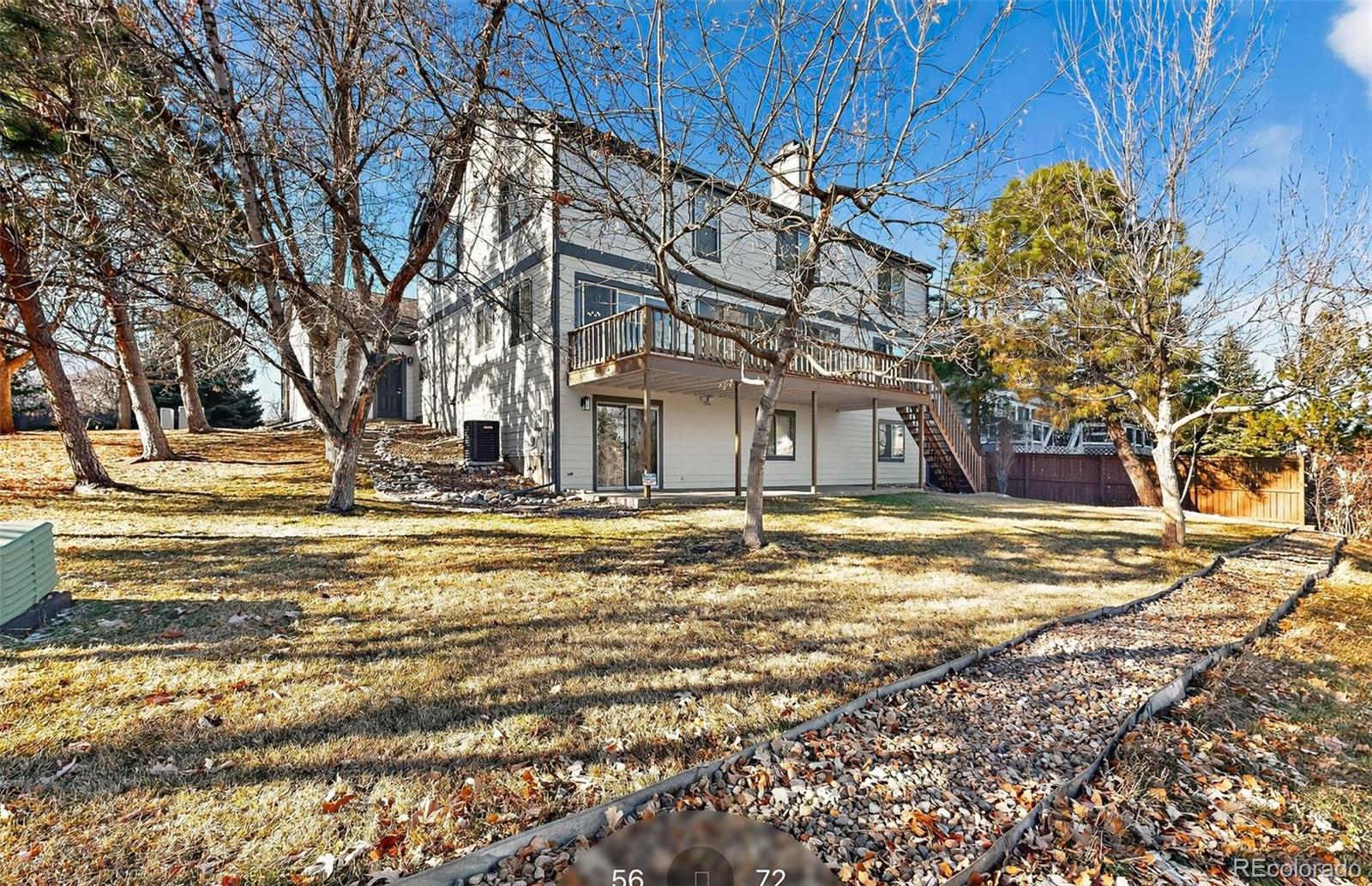 9195 Sugarstone Circle Highlands Ranch, CO 80130 - Photo 22 of 37 a view of a house with a yard