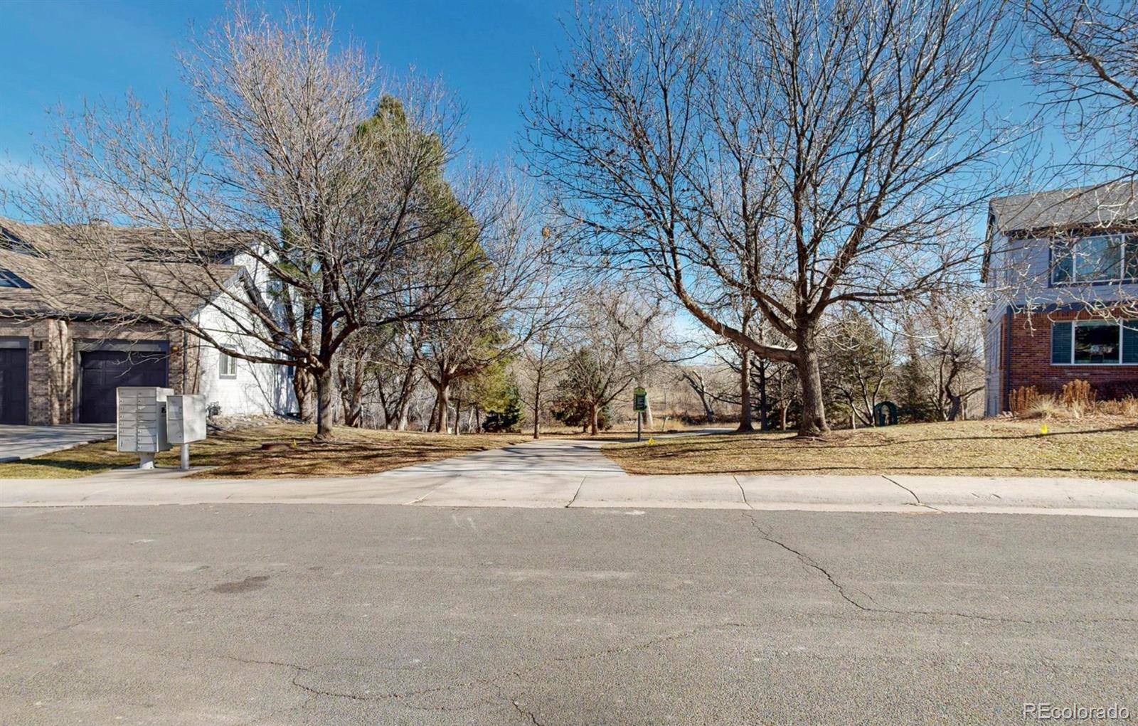 9195 Sugarstone Circle Highlands Ranch, CO 80130 - Photo 23 of 37 a view of a road with a white house