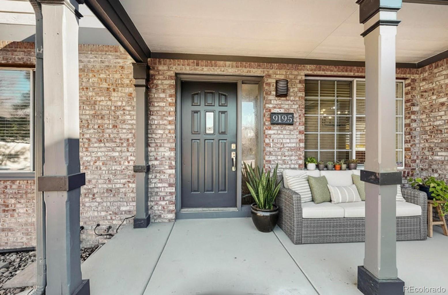 9195 Sugarstone Circle Highlands Ranch, CO 80130 - Photo 3 of 37 a front view of a house with outdoor seating