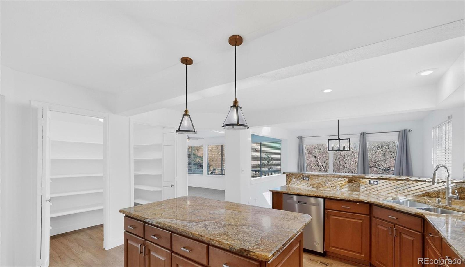 9195 Sugarstone Circle Highlands Ranch, CO 80130 - Photo 6 of 37 a kitchen with sink cabinets and wooden floor
