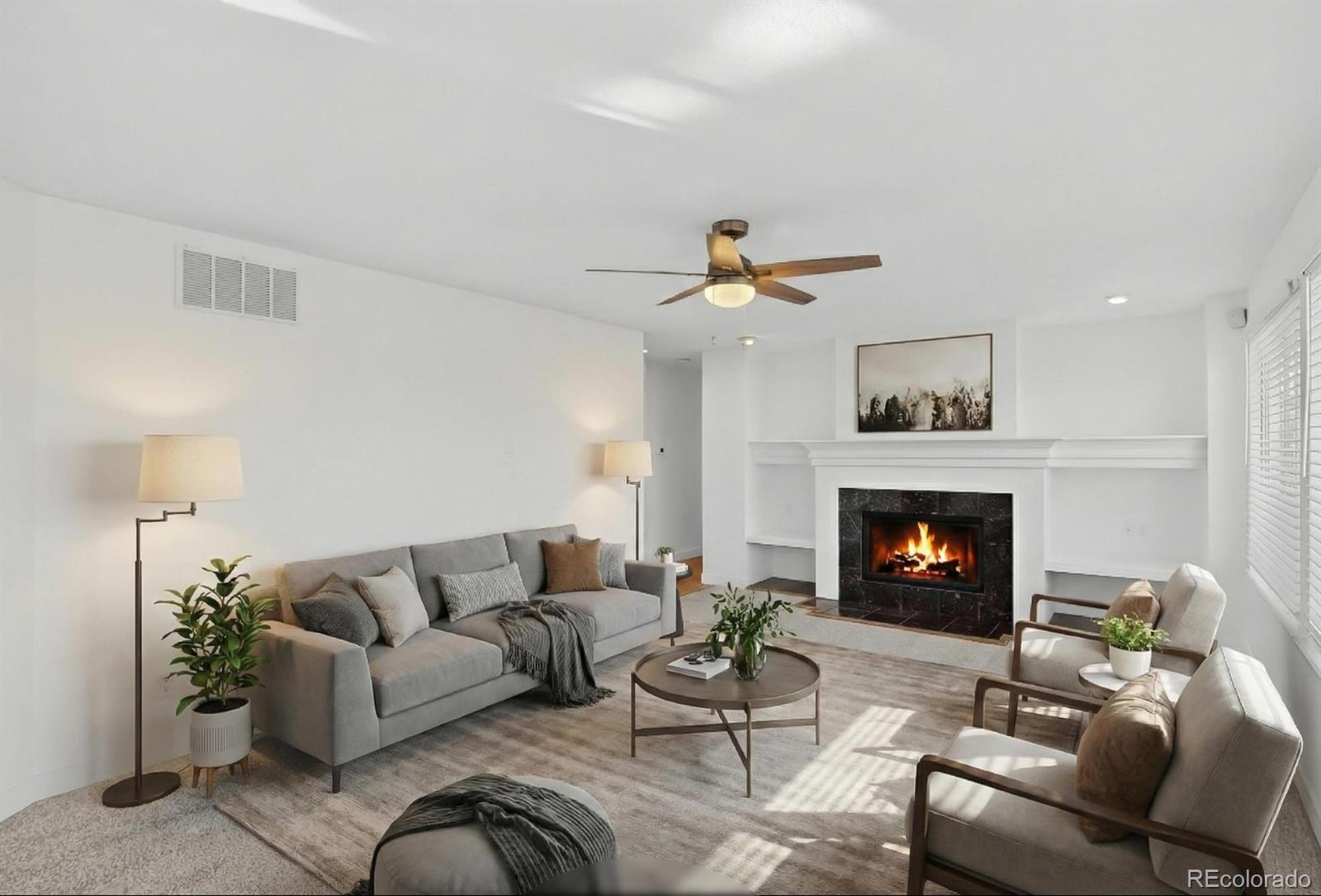 9195 Sugarstone Circle Highlands Ranch, CO 80130 - Photo 10 of 37 a living room with furniture and a fireplace