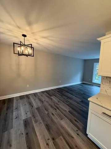 a view of a room with wooden floor