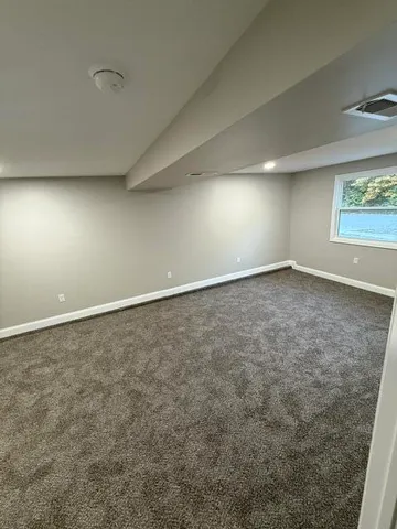 an empty room with a empty space and windows