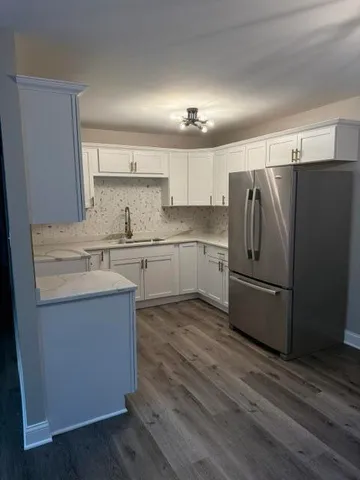 a kitchen with stainless steel appliances a refrigerator sink and cabinets